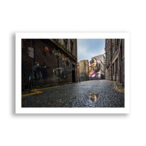 Street art reflected in rain water - Glasgow, Scotland