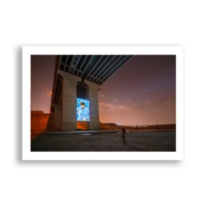 Woman watches projection of "De Anima" by Sarah Brahim